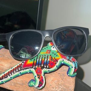 Black lightweight sunglasses. “Love Tito’s” Titos Handmade Vodka.